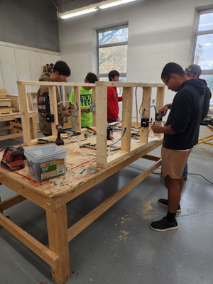 students around a table working on a project