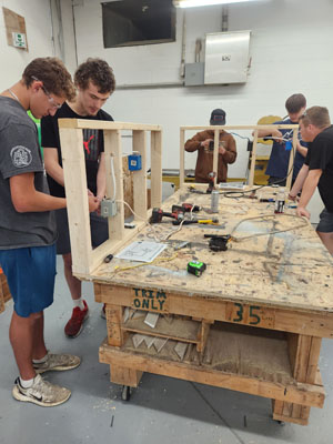 students around a table working on a project