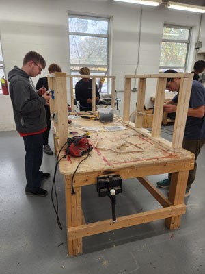 students around a table working on a project